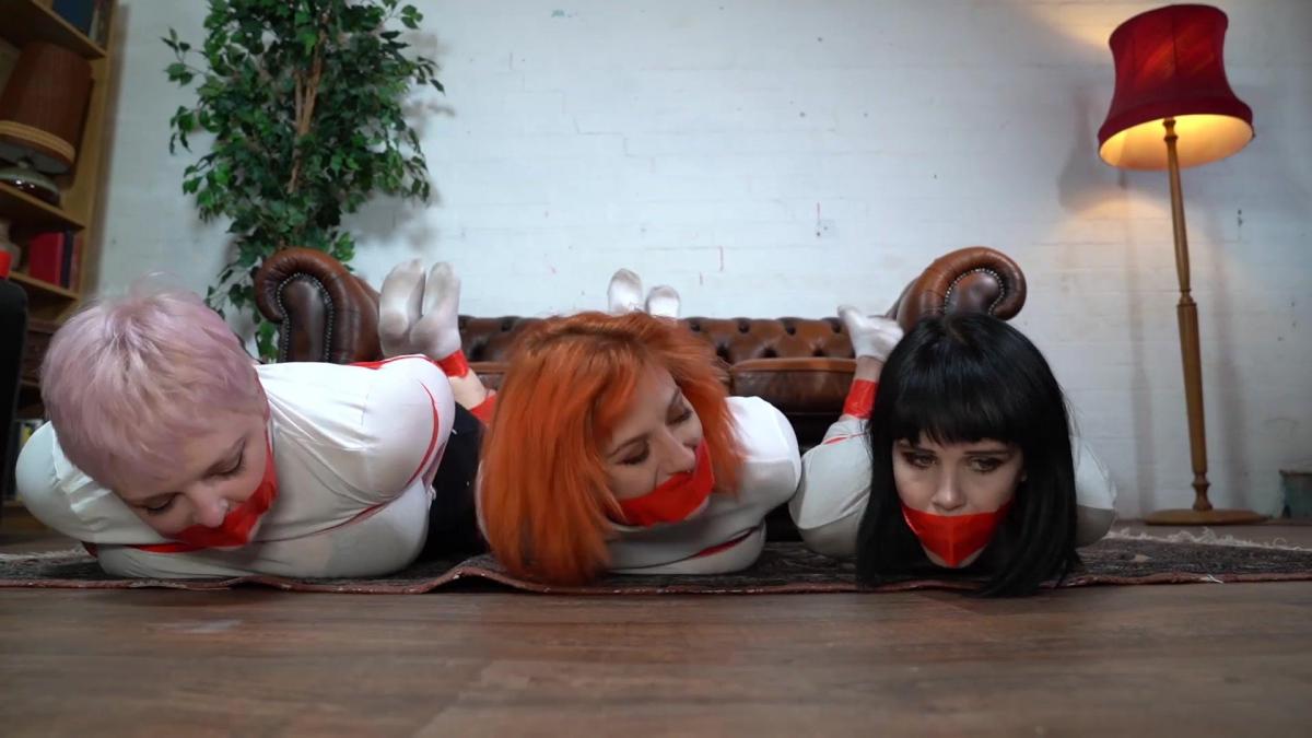 1191 Amber Mia and Roxie in Tape and Socks Three models and lots of red tape. Mia, Amber and Roxie are taped back to back in their shorts and turtlenecks. Then on the floor on their bellies