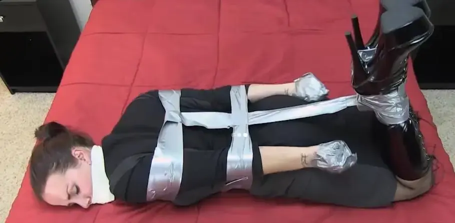 Cherry Doll duct tape hogtie escape Cherry Doll is dressed in a tight fitting black dress, stockings and knee high boots...oh and she's also hogtied with duct tape! Taking it one step further, we tape her hands into mittens with more duct tape and tape her pretty little mouth shut! Left alone to struggle on the bed, it's only the most determined of sluts that will be able to break free of this situation! So what do you think? Can Cherry Doll do it? Can she break free?!? The struggle is what we love her at FetishPros...and when your victim thinks she can escape, the greater the struggle! And so comes the quandary...just how much "wriggle room" do we leave each model?? Watch and see what happens!<br><br>