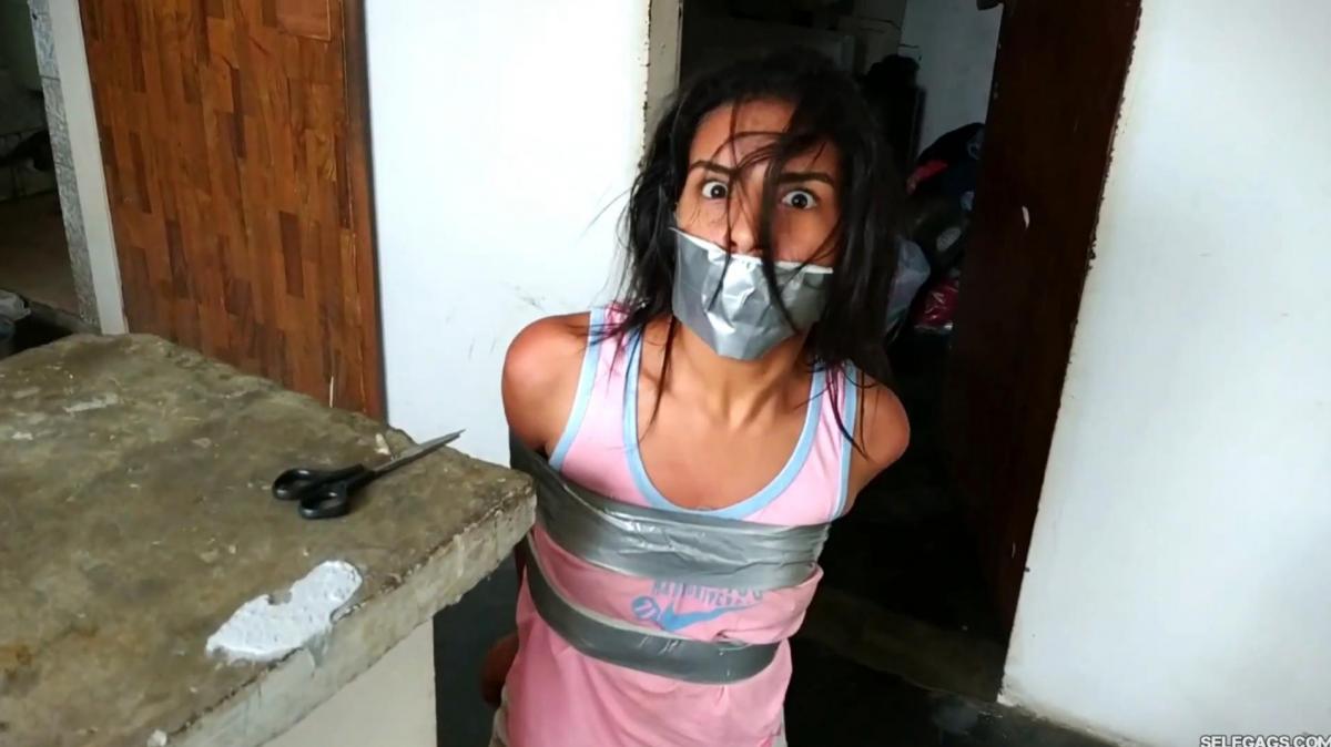 Maria Martinez in: Stalked Cutie Bound And Gagged (high res mp4) From: SELFGAGS<br>Description:<br><br>It is early morning and a wakes up in the attic. She doesn't know where she is or what happened to her. She realizes that she is bound and gagged and that she is still wearing her nightclothes. She must have been subdued, captured, and taken away in the middle of the night!<br><br>We follow the restrained girl's struggle for a way out of captivity as she desperately squirms her body around the floor in the attic, searching for a way out. The squirming damsel soon notices photos of herself on a wall in a nearby room. Someone has been watching her for a long time!<br><br>Included in this clip: tape bondage, squirming, damsel, tapegagged, latina, bound and gagged, struggling, barefoot, stuck, desperation, escaping, gag talk, bdsm, gag fetish<br><br>Clip is 15 minutes and 50 seconds long - 1920x1080 - Dialogue in Spanish