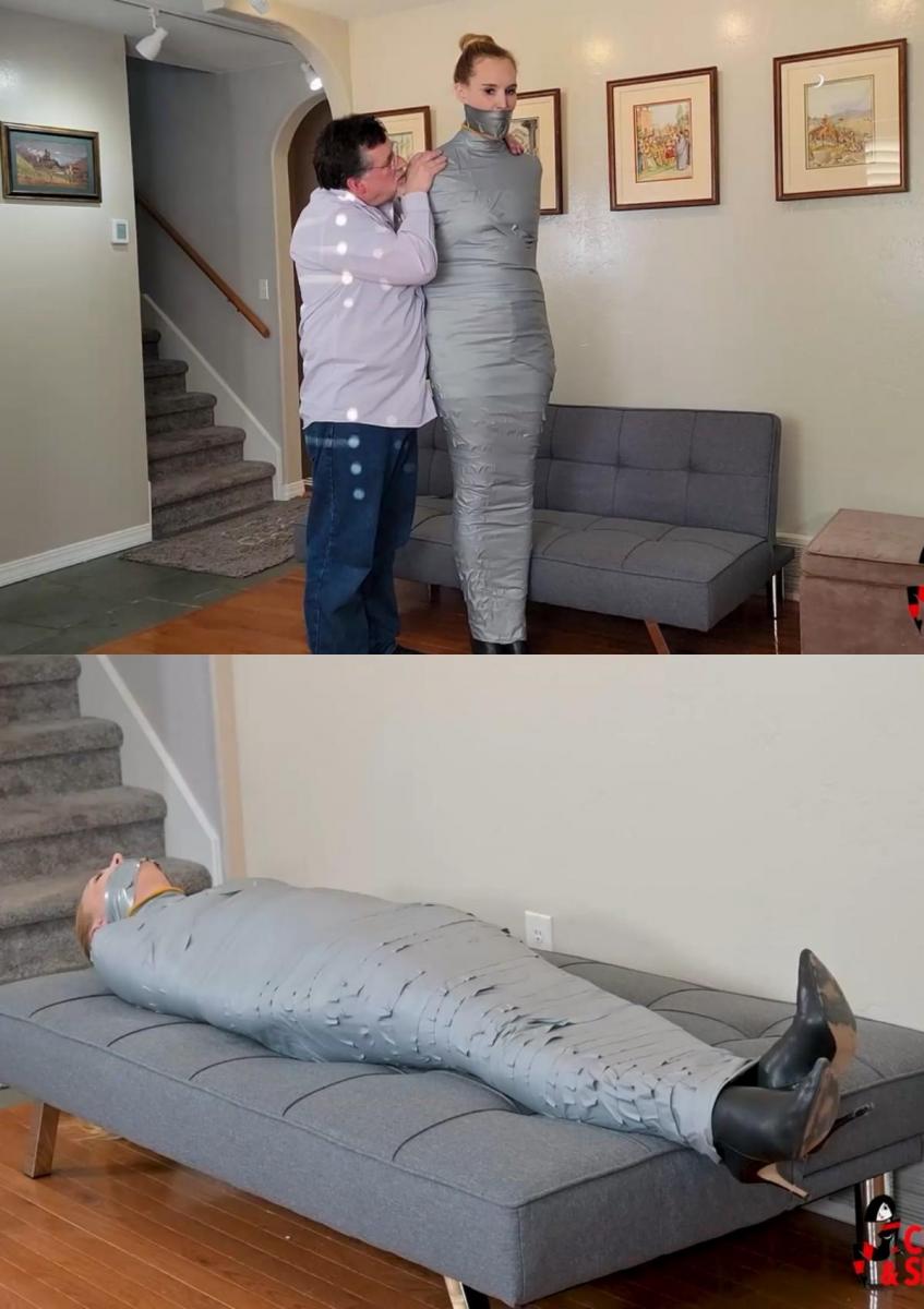 Ariel's Mummified Workout (MP4 Format) Ariel刚走完早上的路，就要回家了。作为日常锻炼的严格倡导者，她以自己苗条性感的身材而自豪。不幸的是，其他人也为她那苗条性感的身材制定了计划！当她走进房子时，一只手粗暴地夹住她的嘴，压制住了她的尖叫声，这让她大吃一惊！在她意识到发生了什么之前，入侵者已经把她从肩膀到脚都裹在了一个紧紧的胶带茧里！她的嘴同样被粘乎乎的灰色材料封住了，掩盖了她在监狱里紧紧拥抱时发出的痛苦呻吟！她仍然穿着高跟鞋，进行着她做梦也没想到的锻炼！首先，她在自己的客厅里一次又一次地跳来跳去，她的包装使她呼吸困难，并压迫她的四肢，直到她的整个身体变成一袋沉闷、疼痛的肉。筋疲力尽的她无力阻止这名男子在她的小腿上缠上更多的胶带，然后他让她在她狭小的座位上水平挣扎。她会逃跑吗？Ariel had just finished her morning walk and was headed into her home. A strict advocate of daily exercise, she prided herself on taking care of her trim, sexy body. Unfortunately for her, someone else had plans for that trim, sexy body, too! When she entered the house she was taken by surprise as a hand clamped roughly over her mouth, stifling her screams! Before she knew what had happened, the intruder had wrapped her from shoulders to feet in a cocoon of tight tape! Her mouth was likewise sealed by bands of the sticky grey material, muffling her groans of pain from the constricting embrace of her prison! Still in her high heeled boots, she was subjected to an exercise routine she had never dreamed of! First, she was hopped back and forth over and over again in her own living room, her packaging making breathing difficult and compressing her limbs until her entire body was a dull, aching bag of meat. Exhausted, she was powerless to prevent the man from wrapping even more tape around her lower legs before he left her struggling horizontally on her small sitting area. Would she ever escape?