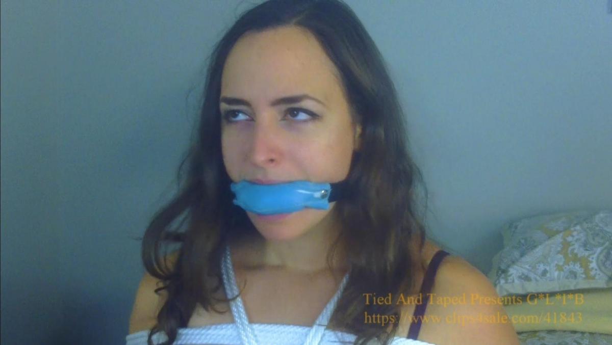 GagMe Inc: Karly Vs The Recovery Expert HD - Karly Salinas, Vivian Ireene Pierce From: Tied And Taped Presents GLIB<br> <br>Description:<br><br>*CUSTOM CLIP*<br><br>Karly start the scene slinking around in fancy lingerie. She is talking on the phone to her lover and making an attempt to convince her to come over to celebrate her leaving the company and getting a HUGE severance package to keep quiet.<br><br>KARLY: Yes, I really want you to come over…yes, right now. I’m all dressed up in my sexiest outfit for you…Yes, I’m celebrating leaving that awful company…yeah, they gave me all kinds of money just to keep my mouth shut…well, they called it a gag order…oh yeah, they were totally series…but you know me, no one shuts this girl up. No, I didn’t sign some stupid waiver. Oh, it’s fine, whatever.<br><br>Karly stands in front of the POV and acts like it is a mirror. She checks herself out by adjusting her boobs, lipstick, whatever, while she continues her conversation on the phone.<br><br>KARLY: So…I want you to get over here and do all kinds of bad things to me…whatever you want…what do you mean like what? …Well, you can bind…you can gag me…yes, whatever you want…I stole a bunch of stuff on my way out…Listen, I want you, please come over? …Okay, bye!<br><br>Karly moves onto the bed. She practices her sexy poses for when her lover will enter the room. She cannot decide which position she looks best in.<br><br>Suddenly, there is a knock on the door. This surprises Karly as there is no way her lover could have made it here so fast. She gets up to open the door.<br><br>Vivian barges into the room. She carries and large bag full of rope and bondage equipment. Vivian is also texting on her phone and is very no-nonsense with Karly.<br><br>VIVIAN: Hello, Ms. Salinas.<br><br>KARLY: Um, do I know you? I didn’t even say you could come in.<br><br>VIVIAN: Yes, you did. Anyway, I’m Vivian and I’m from GagMe Incorporated, Recovery Division. Yes, it seems your resignation has been revoked. I’m going to need you to sit down please.<br><br>At some point Vivian hands a very confused Karly Vivian's business card.<br><br>KARLY: Wait, what the what?!<br><br>FADE OUT/IN<br><br>On the fade in, Karly and Vivian are sitting at the table. Karly is bound and gagged, Vivian is not. Karly is tied in a box tie like she was at the end of the most recent video produced with GLIB. Karly’s legs are NOT tied. Karly is also sporting a VERY tight and VERY uncomfortable crotch-rope tie, as is Vivian under her skirt to be seen at a time below. Karly is gagged with the Blue Leatherette gag I sent/will send in the mail.<br><br>Vivian is reviewing some paperwork she has from GagMe Inc. and is questioning Karly as she struggles in frustration and gag-talk a number of complaints to Vivian . Vivian remains professional and calm as she explains what is happening. Karly will gag-talk protests, insults, complaints and angry mmph’s in response to all of Vivian's statements and questions. Vivian can IMPROV the lines below and her interaction with her prisoner as much as possible. The lines below are only meant as a guideline, she does not have to repeat verbatim<br><br>VIVIAN: I’m sorry I had to bind and gag you Ms. Salinas, but as you know its company policy. But don’t worry, this will all be over for you shortly.<br><br>VIVIAN: So, it says here you recently tried to resign from your position with GagMe? …Okay, I’ll take that as a yes. It looks like you also properly processed, but then you filed a complaint with Terra in the Legal Department….Okay, and then it also appears you also damaged several prototypes in R&D on your way out? Oh, that’s a big no, no.<br><br>As Karly tries to explain with a gag in her mouth, Vivian continues.<br><br>VIVIAN: Look, Ms. Salinas, I’ll cut to the chase. I’m here because you didn’t sign Waiver Form 69, AND you clearly the gag-order by removing your gag in the first place. So, listen, I’ve been with GagMe a LONG time. I’ve worked with the best. I’ve had to process a lot more girls more clever than you. So, we can do this the easy way, or the hard way. A recovery team is on the way and they are going to take us back to GagMe, and you can finish out your work! Simple as that.<br><br>Vivian gets up and pulls up her skirt to show Karly her wonderfully intricate crotch-rope tie.<br><br>VIVIAN: Because, the sooner I bring you in, we can a more permanent one like this one you, and I can finally take this off, because I would REALLY like to have some sex soon. So, what do you say?!<br><br>Karly, gets up and makes a run for it and leaves the shot.<br><br>Vivian pulls her skirt back down, and reaches for the white or red ballgag and begins putting it in her mouth.<br><br>VIVIAN: Ugh. I guess it’s the hard way then. Love my job, I love my job, Love my job…<br><br>FADE OUT/IN<br><br>On the FADE IN, Karly has been apprehended. Her legs are now tied and she is struggling on the bed. Vivian is still gagged and is standing over Karly shaking her head in disappointment. Karly begs to be let go, but Vivian says no way!<br><br>To make sure Karly doesn’t get away, Vivian finds a set of hand-cuffs. Vivian takes off her skirt, showing us that crotch-rope tie and then she gets on the bed with Karly. Vivian leaves her blouse or shirt on though.<br><br>Vivian lays down with Karly and then handcuffs her own hands in the front, but behind Karly’s back. Karly is wide-eyed and shocked and gives Vivian an earful as they press their bodies together. Vivian just says whatever, should’ve signed the waiver. This is Karly’s own fault.<br><br>Karly continues to struggle connected to Vivian and mmph’ing and sexy hijinks ensue until time runs out!