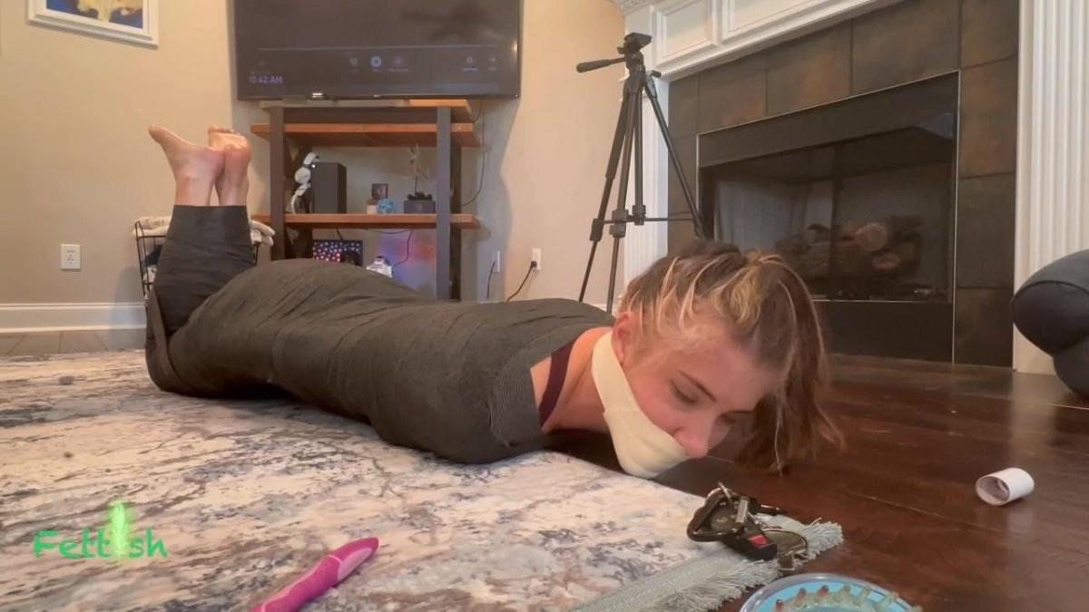 Hogtied, Gagged, and Tickled - Layla Remember Layla? Yes THAT Layla. My female wrestling friend who despises being tickled. I’m honored to say I’m the only one she trusts to do it! Surprises me though as she is no fan of this as I said. I asked what she thought of a mummification, and while she had never ever done one, she agreed! I get her tightly wrapped from ankles to shoulders, then back down again. Lowering her to the floor, I wrap the lower half of her face shut with microfoam, sealing her incoming laughter, and upper the helplessness. No begging allowed. Suffer silently.<br><br>Then it begins. I start out taping My Little Droney (ya like that?) to her feet then hit the on switch. But, my sadism eventually takes over and I help out with a vibrating brush. When that tires me I don the dreaded black gloves and tickle the balls of her feet and toes while Droney keeps doing what it does best. Once more time passes i want a more hands on approach so i remove them entirely then go all gloves, then the flosser, and finally i let he pick the weapon to use. She chose the scalp brush. 