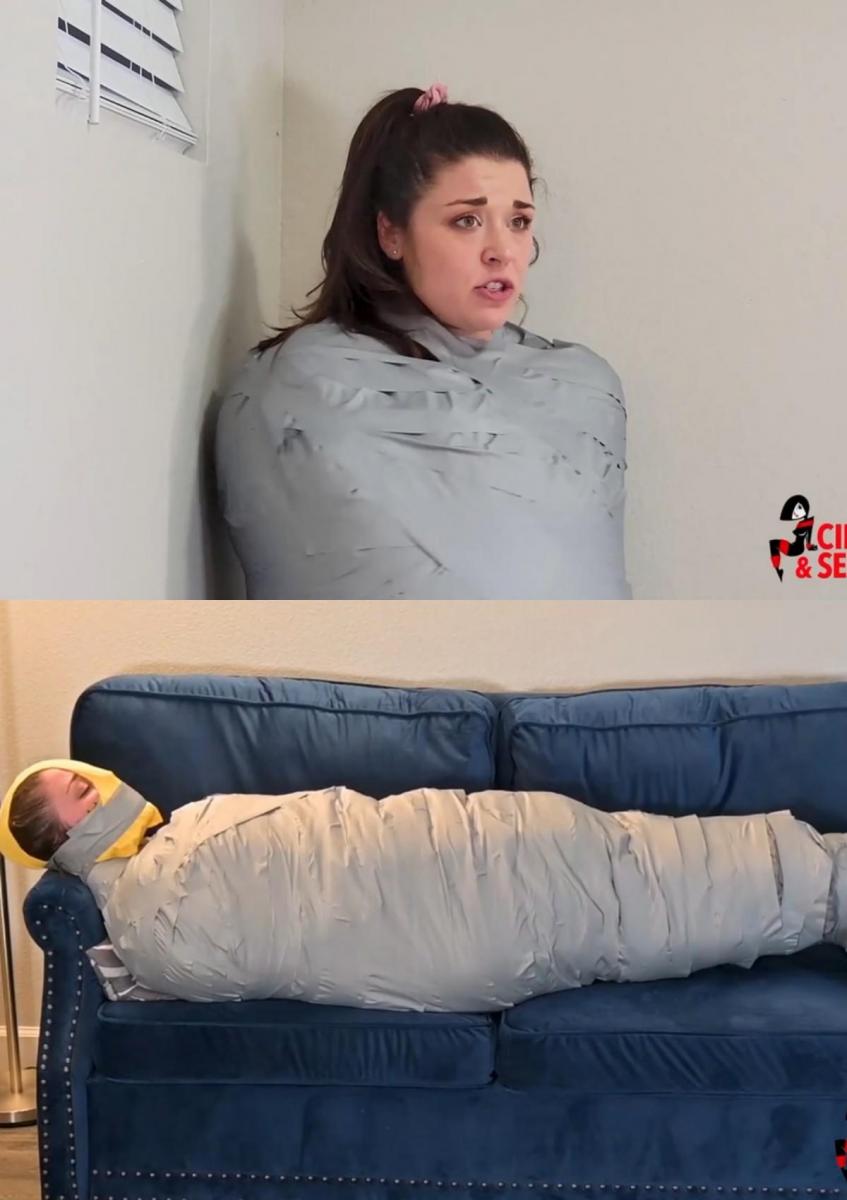 Smytten's Babysitter Mummification (MP4 Format) Smytten 认为保姆会轻而易举。 她同意和这些小屁孩玩个游戏，但很快就发现自己被包裹在一个厚厚的毯子茧里，从脖子到肩膀都用黑色电工胶带紧紧地绑着！ 当她扭动和跳跃时，她咀嚼着小怪物，要求它们释放她。 他们想到了其他想法，将她已经变成茧状的身体塞进了一个午睡袋中，从头到脚贴在上面！ 现在她真的很无助，只能求他们饶命，天真地问他们还能对她怎么样？ 当他们把她放在沙发上并用一条巨大的脏内裤塞住她的嘴时，她发现了！ 把那些贴好后，他们终于摆脱了她所有的抱怨！ 虽然她仍然发出很大的声音，所以小混蛋们在她已经[X_X]的堵嘴上绑了两只厚袜子，然后把胶带一遍又一遍地缠在她的脸上！ Smytten 现在已经惊慌失措，大声呼救，但唯一能听到的声音是一连串低沉的咕噜声和尖叫声。 决定她需要更多的羞辱，小屁孩把另一条旧的脏内裤拉到她的脸上！ 他们用胶带牢牢地粘住兜帽，离开了她，她扭动着、反抗着、愤怒着，被困在茧里，被塞满的多层塞子堵住了嘴巴！ 看起来 Smytten 赢得了她的报酬！Smytten thought babysitting would be a breeze. She agreed to play a game with the little brats, and soon found herself encased in a massively thick blanket cocoon, taped from her neck to her shoulders with tight black electrical tape! As she squirmed and hopped, she chewed out the little monsters, demanding for them to release her. They had other ideas in mind, and slipped her already cocooned form into a napping bag, taping over THAT from head to toe! Now she was truly helpless, and she pleaded with them for mercy, innocently asking what more could they do to her? She found out as they lay her on the sofa and packed her mouth to bursting with a giant pair of dirty panties! With those taped in place, they were finally free of all her complaints! She was still making a lot of noise though, so the little jerks tied two thick socks over her already stifling gag and then wound the tape around her face again and again! Smytten was panicked by now, screaming for help, but the only sounds to be heard were a deeply muffled series of grunts and squeals. Deciding she needed a little bit more humiliation, the brats pulled ANOTHER pair of old dirty panties over her face! They taped the hood securely and left her, squirming, bucking and furious, trapped in the cocoon and silenced by the massively stuffed multi-layer gag! Looks like Smytten earned her pay!