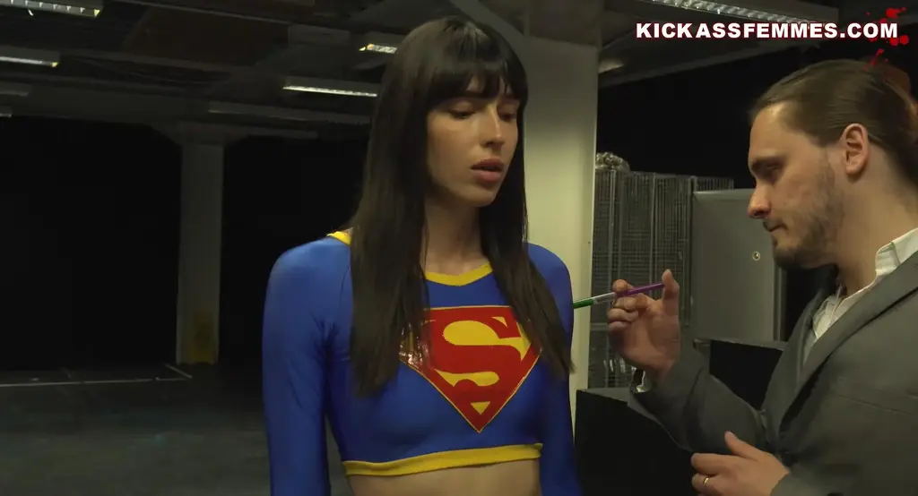 GLASS FEMMES [4K] SUPERDANICA DEBUT!  When this beautiful supermodel / superheroine is lured into a trap SuperDanica finds herself at the mercy of the immensely powerful 'businessman' Max Lord.  It all started out so well for SuperDanica, she beats up some street low life street muggers, saves a couple of lives and even has time for a bit of shopping... that's until Max Lord and his beefcake sidekick, Zero,  offer her a deal she can't refuse.  SuperDanica agrees to fight Zero for a million dollar charity donation, she even agrees to take a power sapping serum to level the fight out but naturally it's still too easy for her as she batters this roid rager with her brutal martial arts. This is when it gets darker, she gets drugged beyond what even an immortal being can take and is so weak she finds herself in total peril. Zero proceeds to batter SuperDanica to a pulp... she screams for mercy as he lands blow after blow but will he listen?  there's a sinister plot afoot and this involves reducing this superheroine to nothing.  Will this total physical annihilation of SuperDanica ever stop?.... all will be revealed.