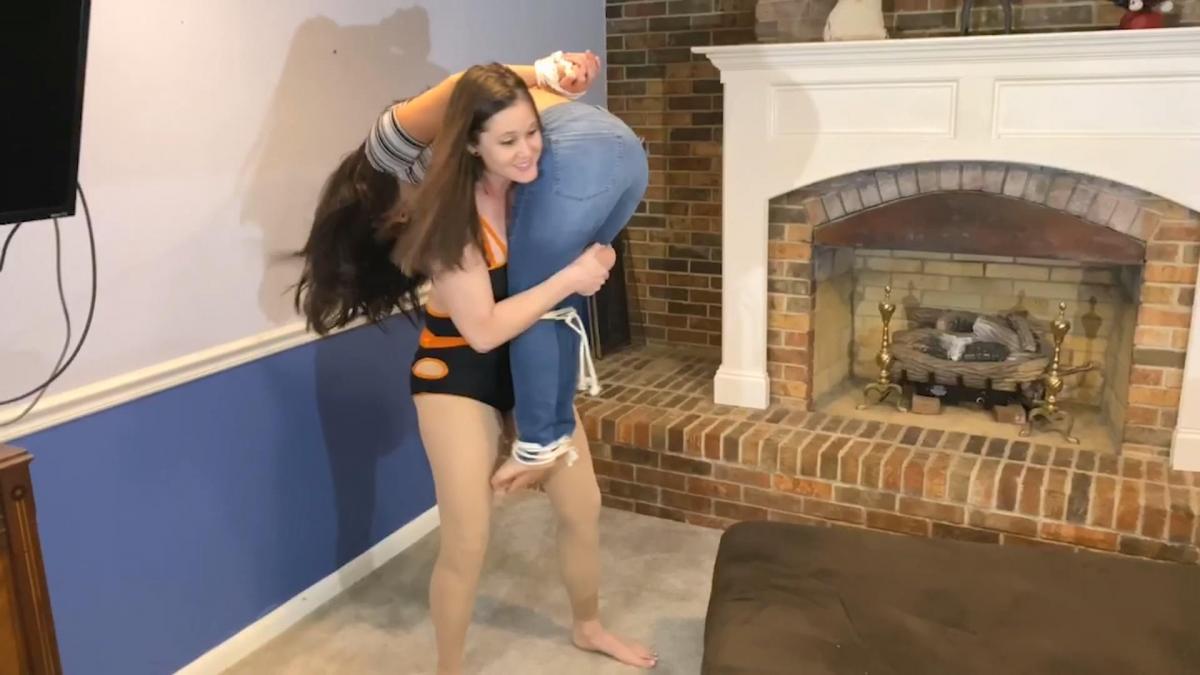 Rock-C Tickles Sumiko Sumiko breaks into Rock-C's house looking for something valuable to steal and pawn. Rock-C catches Sumiko snooping around her house and knocks her down. Rock-C makes fun of Sumiko's outfit choice before deciding she's going to tie Sumiko up and "make her her little plaything." Rock-C takes her time tying Sumiko around the waist, tying her wrists behind her back and also tying her ankles to make sure she will be nice and helpless. Once she's done tying Sumiko up, she picks her up off the floor and tosses her onto the couch and sits behind Sumiko while she wakes up. Sumiko panics and tries to get free but Rock-C has other plans for bound Sumiko. Rock-C begins to poke at Sumiko who begins to giggle although she denies being ticklish. Rock-C has fun tickle teasing Sumiko on her belly and neck, even using a hairbrush on Sumiko sending her into fits of screaming laughter. Sumiko begs Rock-C to stop, saying she hates being tickled more than anything! Rock-C enjoys seeing Sumiko like this and continues to tickle and talk smack about her slutty outfit choice in between ticking. Eventually Rock-C eventually decides to throw Sumiko over her shoulder and take her away to her tickle room to have more fun with her. <br><br>attacks: punches to face/head, tying up, tickling and slapping of belly, tickling her neck, using hairbrush as tickle tool, over the shoulder carry