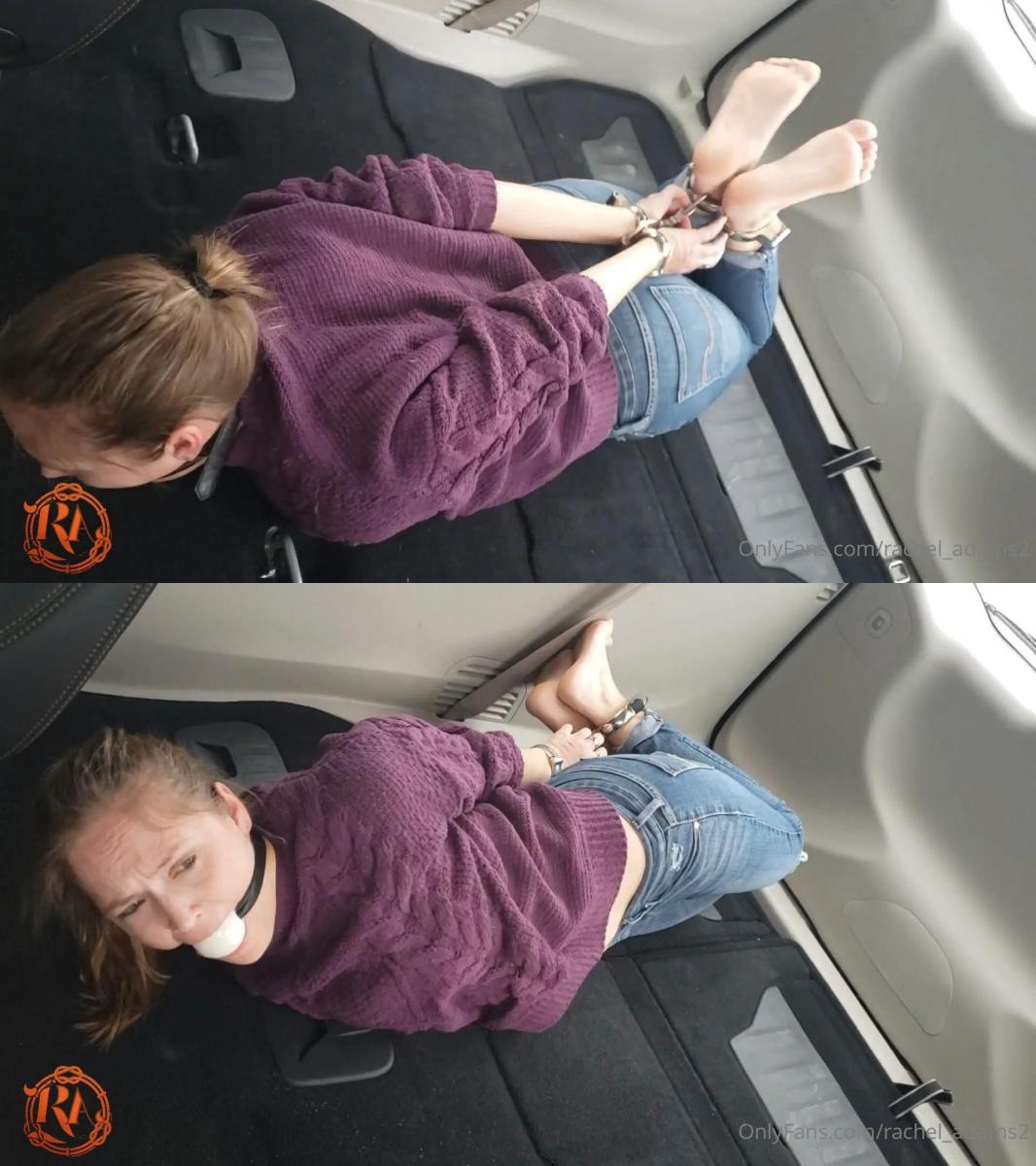 hogcuffed in the car for transport part 2 逮捕她的人认为她行动能力太强，所以他把她铐在了货车后面。 她在大手铐中挣扎，在严格的金属束缚下无法动弹。 her captor decides she has too much ability to move, so he hogcuffs her in the back of the van. she struggles in the hogcuff, unable to budge in her strict metal bonds.