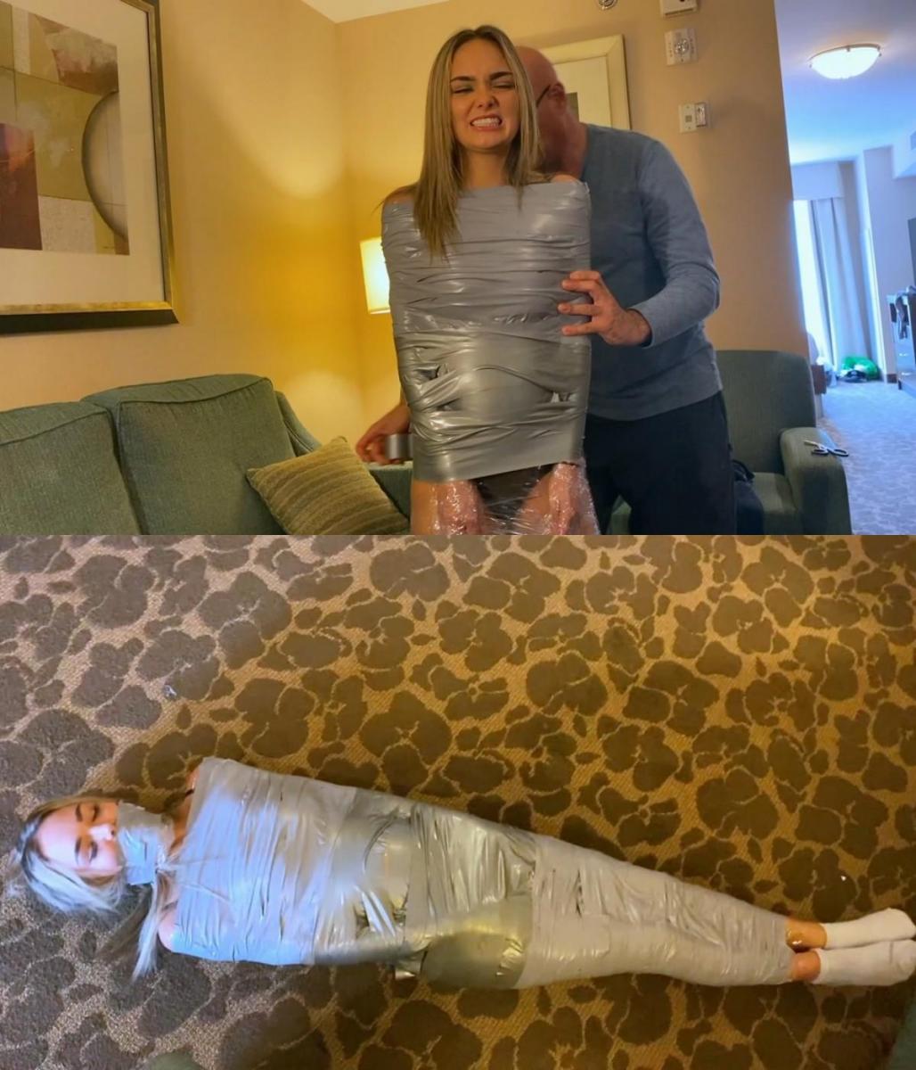 Mummy Escape 布莱克·拉维斯塔 (Blake LaVista) 让她的朋友把她的手臂绑得很紧，这样她就无法出去。 她抱怨他没有使用足够的胶带，而她很容易就摆脱了束缚。 她要求绑得更紧！ 他将胶带缠绕在她性感的身体上，最终布莱克完全木乃伊化了！ 布莱克会获得自由吗？ 她确实脱掉了袜子！Blake LaVista asks her friend to tape her arms really good so she can't get out.  She complains that he is not using enough tape and that she can easily get free.  She demands to be taped tighter!  He winds the tape around her sexy body and eventually Blake is completely mummified!  Will Blake get free?  She does get her socks removed!