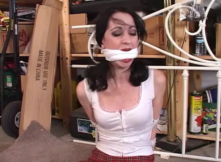 2309MINA-Neighbor girl hogtied &amp; gagged in the garage Since her car was broken down, Mina had been getting a ride to class from her neighbor. But today when she went over, her neighbor was not there. Instead she was met by a strange man who turned out to be a robber. He needed to keep Mina out of the way while he waited for the neighbor to return home. But he couldn't just couldn't just let her leave. So he her into the garage where he found some rope. He tied her up and stuffed a pair of panties in her mouth to gag her. To make sure she couldn't spit the panties out, he tied a rag tightly between Mina's pretty red lips. Mina squealed loud as she tried to get the gag out of her mouth. She struggle with him as he her on her stomach so he could hogtie her. Luckily for her Mina's neighbor, she was stuck in traffic and didn't make it home for hours. The robber got tired of waiting and left. Mina would struggled hard to get loose. But it would be a while before her neighbor would get home and find the cute little coed all tied up & gagged in her garage.<br><br>