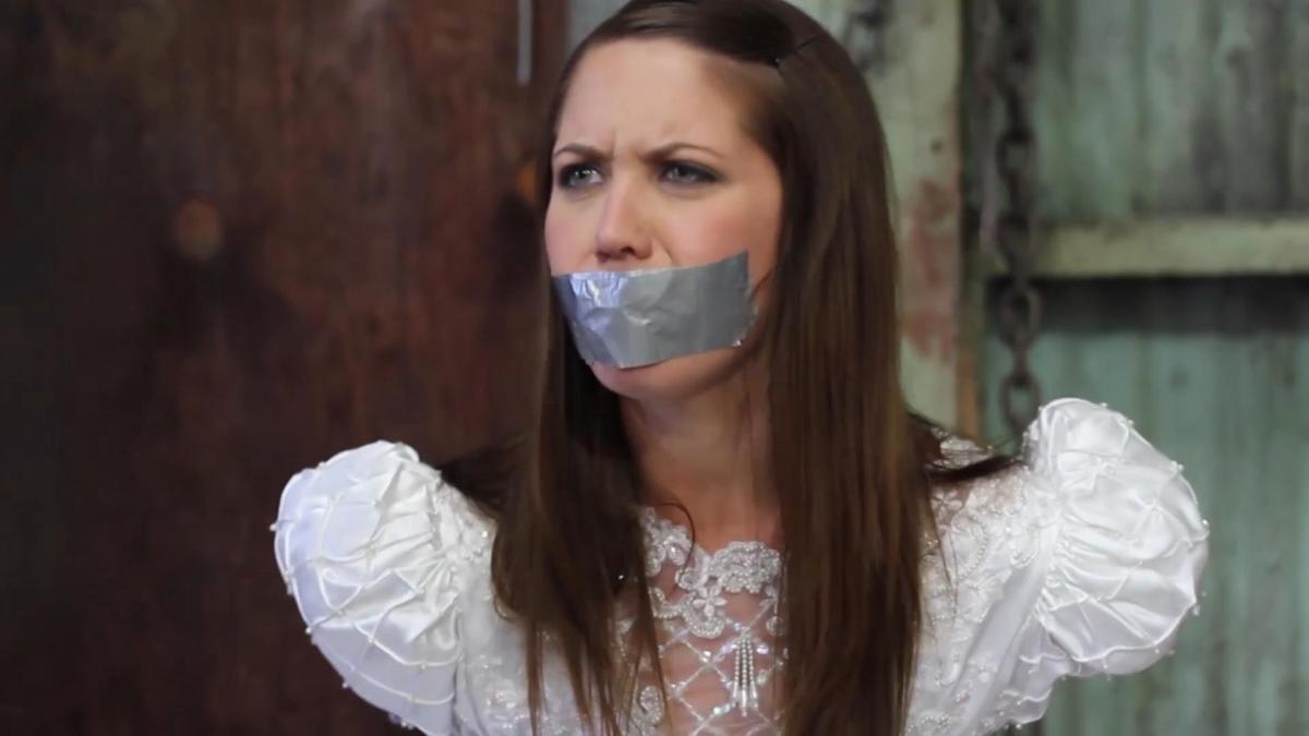 CHRISSY MARIE GETS TIED AND GAGGED THE DAY OF HER WEDDING BY THE JEALOUS EX GIRLFRIEND CASSEY Description:<br>Chrissy Marie is a few minutes from getting married, she's fixinf the last details of her hair when suddenly Cassey walks into the dressing room, she is the ex girfriend of Chrissy's fiance and she is not happy about the wedding, so Cassey grabs Chrissy with a handgag and gras her to her car, then drives her to an abandones warehouse where she ties Chrissy up, then stuffs a piece of cloth in her mouth and finally gags her with duct tape! Chrissy struggles as hard has she can but all she gets is Cassey's laughs! But justice is serve when a worker of the warehouse finds the girls and overpowers Cassey, the dude unties Chrissy who explains him everything. The good samaritan tells Chrissy he will drive her to the wedding but before that they decide to give Cassey a taste of her own medicine and they tie her up and gag her