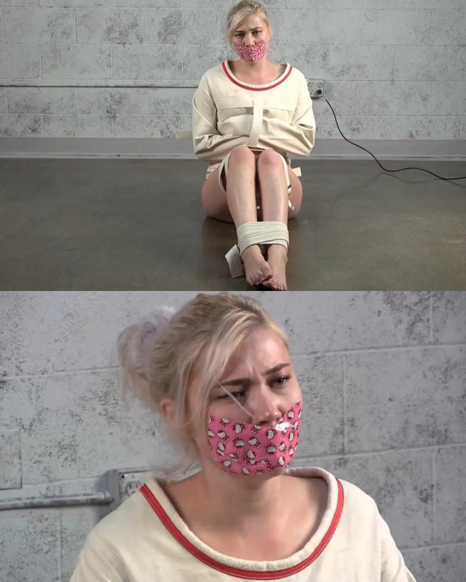 MISHA MAYFAIR: STRAITJACKET AND HELLO KITTY DUCT TAPE 米莎很可爱，很克制，无助地躺在地板上。 她的双腿被医疗束缚包裹着，并被一件厚重的紧身衣固定住。 她的嘴唇被 Hello Kitty 胶带封住，让这只小可爱更加可爱。Misha is adorable restrained and left helpless on the floor.  Her legs wrapped in medical restraints and secured in a heavy institutional straitjacket.  Her lips are sealed shut with Hello Kitty duct tape, making this cutie even more adorable.