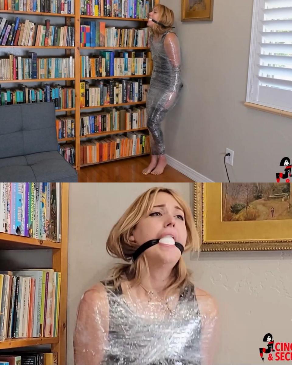 1411 - Cara Day - Mummified Yoga Girl - Part 1 卡拉·戴 (Cara Day) 正在享受下午的瑜伽课程，伸展她瘦弱的身体，用每个姿势拱起双脚，这时她对一个入侵者感到惊讶。 他一心要抢劫这个地方，而且不太相信她会按照他的指示留在原地，所以他把这个可怜的女孩从脚踝到肩膀包裹在极其紧绷的保鲜膜里！ 卡拉变成了一根无助的柱子，被留在角落里，除了扭动和轻微地扭转她的躯干外，她什么也做不了，同时她努力用融合的双脚保持平衡。 当她狂热地努力保持直立时，她漂亮的涂着颜色的脚趾在坚硬的地板上乱抓，很快她的挣扎就把入侵者拉回到了她身边。 似乎在搜查她的卧室时，他发现了她的一个口塞，然后他深深地[X_X]她的嘴里，野蛮地扣在她的脖子后面。 现在除了难以理解的咕噜咕噜的呻吟声外，她陷入了沉默，她仍然靠在角落里，口水从她嘴里流下来，顺着下巴流下来，增加了她的屈辱。 接下来会发生什么？ （请在第 2 部分中找到答案！）Cara Day was enjoying an afternoon yoga session, stretching her lean body, arching her feet with every pose when she was surprised by an intruder.  He was bent on robbing the place and could not very well trust her to follow his directions to stay put, so he wrapped the poor girl from ankles to shoulders in agonizingly tight, highly constrictive plastic wrap! Cara had been transformed into a helpless pillar, left propped in a corner and unable to do little more than writhe and minutely twist her torso as she struggled to keep her balance on her fused feet. Her pretty painted toes scrabbled at the hard floor as she worked feverishly to remain upright, and soon her struggles drew her intruder back to her. Seems that while searching her bedroom, he found one of her ball gags and he plunged deeply into her mouth, buckling it savagely at the back of her neck. Now silenced except for her unintelligible gurgling moans, she remained propped in the corner, the drool that poured from her mouth and ran down her chin adding to her humiliation.  What was to happen next? (Find out in part 2!) 
