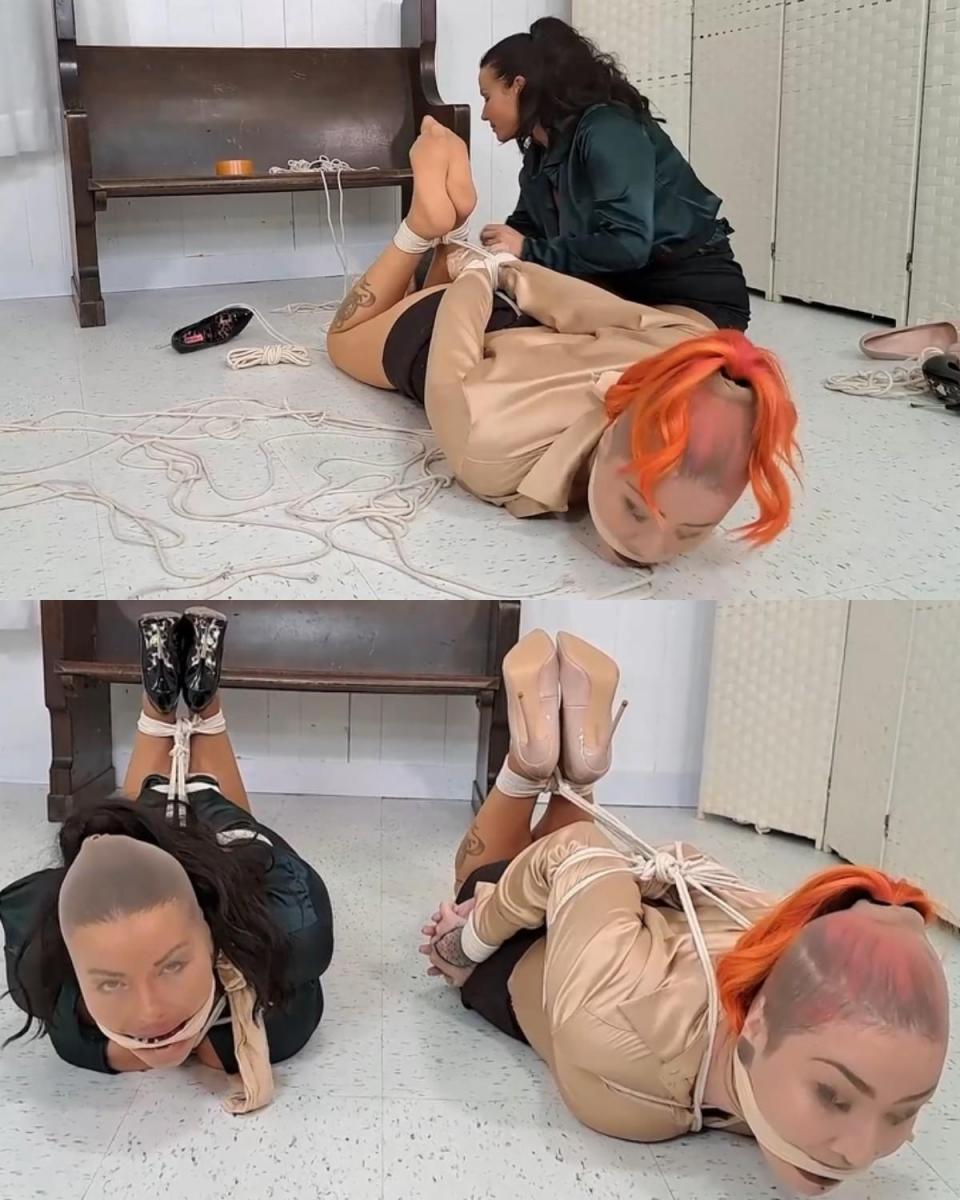 The promotion game 莱利·简和 JJ 正在争夺工作晋升。 他们看起来被绑在袜子上，嘴里塞满了东西，并用尼龙来固定填充物。 女士们努力摆脱束缚，在 JJ 的带领下，最终解开了自己的束缚，并为莱利重新绑上束缚。Riley Jane and JJ are competing for a promotion at work. They appear hogtied with stocking caps on with their mouths stuffed and nylons being used to hold in the stuffing. The ladies work hard to escape the binds with JJ taking the lead and eventually untying herself and retying Riley.