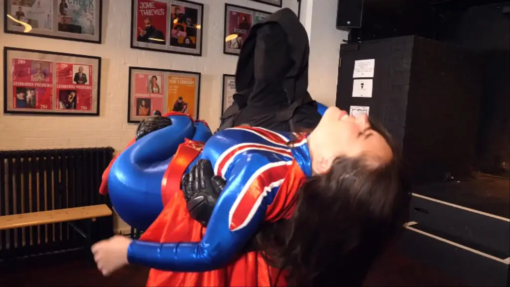 DIRE DONATION our superheroine Majesty's charity fundraiser on the Heroine Network turns into a disaster when Nemesis get-crashes the event with a large donation. If Majesty wants his money for charity, then all she has to do is fight him in an exhibition match in front of the cameras. Majesty is wary, but can't let her charities down. A squash on live TV follows...