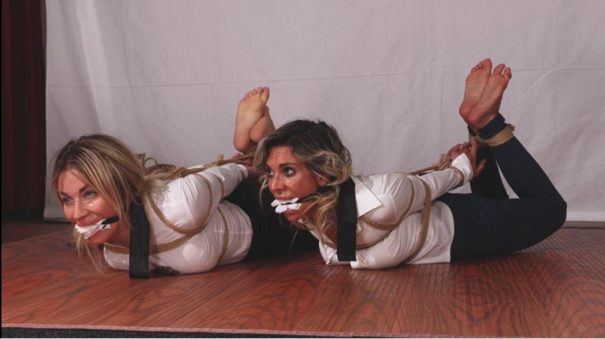 Pamela and Eleonora - The list Layla Bondage Addiction<br><br>Eleonora works for the witness protection program and Pamela is a cop operative. They are talking about a witness who is in real danger when they are surprised by an intruder who is looking for the location of the witness, he hogties them both gag them with a cleave gag with mouth stuffing then he goes look on eleonora pc for the information. He cannot find it so he come back at them makes them strip to their underwear, he frogtie pamela on the floor,arms in a box tie, panel gag her and tie her toes to her hair. Pamela is left to struggle while he ties Eleonora spread eagle on a bed, to make her talk he stretch her strapped limbs to the bed harder and harder while a neck rope connected to her wrists makes her suffer for air even more. He gets the info he needs and leave both women helpless