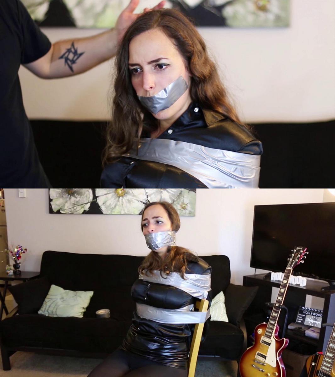 Karly Salinas in black leather and satin tied up to a chair and wraparound tape gagged! 卡莉·萨利纳斯 (Karly Salinas) 穿着黑色皮革和缎子，绑在椅子上，用胶带堵住嘴！ / Karly Salinas in black leather and satin tied up to a chair and wraparound tape gagged!<br><br>卡莉·萨利纳斯 (Karly Salinas) 穿着闪亮的黑色缎面衬衫和黑色皮裙，搭配不透明连裤袜，看起来令人印象深刻。 但她被银色胶带紧紧绑在椅子上，看起来更令人印象深刻！ 绑她的坏人把一条内裤塞进她嘴里，然后用一个非常有效的环绕胶带堵住她的嘴。 为了确保她无法逃脱，坏人用胶带将她绑了起来。 卡莉是逃不掉的！ 最好的胶带束缚与这个行业最好的模型之一！<br><br>Karly Salinas looks impressive wearing her shiny black satin blouse and black leather skirt, with opaque pantyhose. But she looks even more impressive tightly tied up to a chair with silver duct tape! The bad guy who tied her stuffs a pair of panties in her mouth and then gags her with a very effective wraparound tape gag. And to make sure she can't escape the bad guy ties her with zip ties over the duct tape. Karly won't be able to escape! The best tape bondage with one of the best models of this industry!