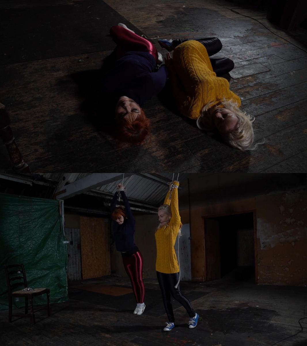 2296 Amber and Chloe in Attic Dangle 安布尔和克洛伊都被戴上手铐，被押进阁楼。 他们被铐在一起等待，然后又用一些旧绳子绑在椽子上。 然后它们就被留在令人毛骨悚然的阁楼里晃来晃去。 Amber and Chloe are both handcuffed and being frogmarched into the attic space. Cuffed together they wait as in turn they are tied to the rafters with some old ropes. They are then left to dangle in the creepy attic.
