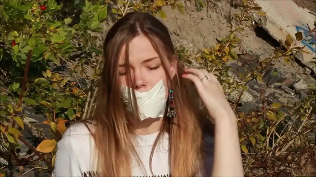Teresa in: Gagged Glamour Model Teresa is your typical girl next door but she's also a glamour model. Teresa is in her early 20's and today she is hired for a rather unusual job where she have to be gagged outdoors. Something she has never tried before. Wearing sunglasses and looking like a hot little diva, Teresa pose and and playfully flirt with you before she sit down on a rock and slowly take one of her shoes off to show off her sock-clad feet. Teresa knows you like her sexy little feet but she also know you're to see her take off her sock and stuff it in her mouth. So that's exactly what this stunning litttle hotties does! Teresa is so beautiful with her mouth totally stuffed with her own worn sock and soon it is covered with a nice layer of white duct tape and a black pair of fishnet pantyhose pulled down over her head!
