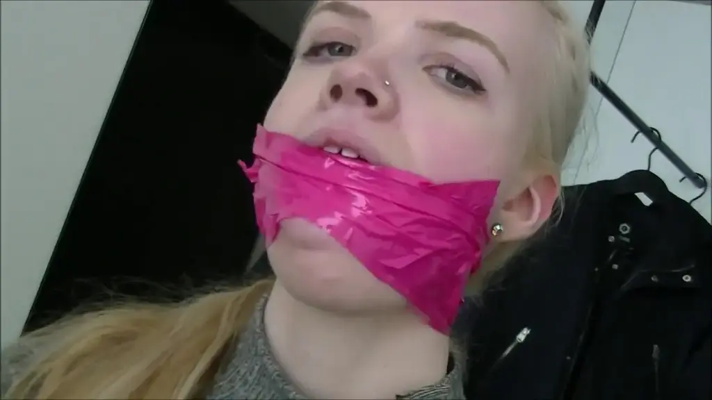 Vanessa in: Self-Gagged &amp; Moaning: Mouth-Filling Gags Makes Her Horny! Get ready for a marvellous self-gagging adventure with ravishing Vanessa! The beautiful blonde from Scandinavia wanted to show us some of the gags she likes in what turned out as this incredibly sexy gag demonstration that quickly became one of our favorites! Vanessa takes one of her thongs and holds it up in front of her gorgeous face. She sniffs the thong and seems to have mixed feelings about the way it smells. Vanessa wore this thong all day yesterday so it's nice and ready to be used as a silencing mouth stuffing - but will she do it? Hell yeah she will! Vanessa slowly starts to pack that worn thong of hers into her mouth while she softly moans like the dirty she really is. She opens up her stuffed mouth wide and puts two beautiful pieces of small width silver duct tape between her lips. The clear view of the black thong behind the silver tape is amazing. Vanessa moans and sensually teases us with her begging eyes as if we gagged her. It is obvious that she is getting turned on by having her worn thong taped in her mouth and she generously allows us a couple extreme close-ups of her gagged mouth before moving on to the next gag.<br><br>Vanessa slowly peels the tapegag off her face and pulls the thong out of her mouth. She reach for a pair of her pink socks and holds them up with a distance to her face. Vanessa sniffs her socks but is looking more opposed to the way those smell compared to the worn thong she just taped in her mouth. Nevertheless, Vanessa decides to stuff them dirty socks into her mouth. The adorable blonde slowly stuffs the first sock in and it completely occupies her pretty little mouth. There doesn't seem room for another sock but Vanessa is determined to get them both in there at all costs! She opens her stuffed mouth as wide as she possibly can and surprisingly manage to find room for the other sock in there too! That is one heavily stuffed up mouth you got there, Vanessa! Those dirty socks are deeply packed into Vanessa's cheeks and filling every little corner of her mouth. Vanessa grabs a roll of white vetwrap and creates a heavy, tight and stunning multilayered wrapgag that causes her luscious lips to bulge out! It is almost painful to watch Vanessa sit there with that super tight cleavegag on her mouth which totally secures those dirty socks inside. Our girl is seriously gagged just the way she like it and she moans as much as that huge wad of dirty socks trapped inside her mouth allows her to. The helpless look in Vanessa's eyes combined with her gagged moaning makes it clear that wearing this heavy monster gag turns her on badly!<br><br>Vanessa remains wrap gagged and moaning for a good while until she decides to move on and demonstrate her third and final favorite. The massively gagged sweetheart frees herself from the multiple layers of vetwrap wrapped around her face and pulls the dirty socks out of her mouth. Vanessa takes a pair of her panties and sniffs them. She wore these today so they are fresh and juicy. Vanessa likes the smell of her panties and sensually starts to stuff them in her mouth while she moans. She makes her worn panties fit into her stretched mouth and grabs a pink roll of bondage tape. Vanessa wraps the tape around her head and in between her lips over and over again until she has made herself a really tight and good-looking tape cleave gag! She touches her gag and enjoys the tightness of it. Her upperlip is left untaped and bulges out over the tape gag with her front teeth biting down on it. Vanessa seems to be fascinated by cleave gagging and lip bulging. Is it the extremely tight pressure it keeps on her mouth she likes so much? Vanessa moans and feels her beautiful gag. She has tape gagged herself tight with the taste of her worn pussy juice panties in her mouth and she loves it! 