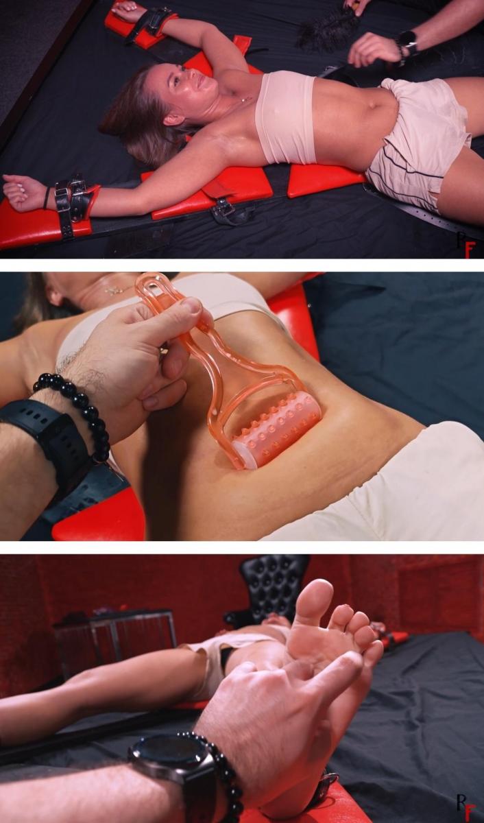 Ticklish Test of Lydia's belly and navel with ice, marmalade, wax and with claps on the cross  Lydia finds herself bound to a cross on a mattress. Today marks the beginning of a series of tests that have already achieved classic status. All of these trials are about to center on Lydia's belly.<br>To start off, I delicately tickle Lydia's body, setting the stage for what's to unfold. This is followed by a gentle stomach massage, with the playful insertion of my finger into her navel. I then place my palm on her stomach, exerting a slight pressure. While doing so, I ask Lydia to count out loud, with my hand remaining in place.<br>Progressing further, I proceed to nibble on her belly and introduce the Wartenberg pinwheel for added sensations. My finger once again ventures deeply into Lydia's navel.<br>Moving on, I shift my focus to tickling Lydia on her sides, following it with a light slap on her stomach. My attention returns to her navel as I insert ice tongs, parting them and subsequently resuming the tickling of her tummy.<br>Recalling some earlier actions involving different tools, I repeat certain maneuvers, including more tickling and another gentle slap to Lydia's stomach.<br>At this point, I introduce marmalade into the scene, placing it within Lydia's navel, and then playfully consuming it before tickling her stomach with my teeth.<br>Building on the intensity, I escalate the tickling on Lydia's body and once again plunge my finger into her navel, all while she continues to count.<br>A return to the marmalade ensues, this time from her small navel.<br>The scene transitions as I take an ice cube and glide it over Lydia's warm belly. As the ice melts, it leaves a puddle within her navel, providing a fresh avenue for the more playful tickling of her quivering tummy.<br>Laughter fills the air as Lydia succumbs to the tickling. Returning to the marmalade and resuming interaction with the ice cube, I culminate the playful episode by introducing a candle. With its wax dripping onto Lydia's navel, a new sensation unfolds—her first experience of this kind.<br>Subsequent to this novel experiment, I engage in a prolonged session of tickling with the now-glistening, perspiring Lydia, before eventually allowing her release.<br>