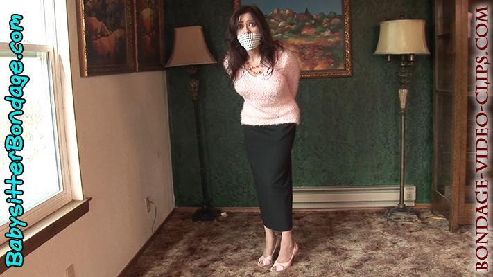 Mom &amp; Secretary Natasha Flade Plays Hostage Game in Sweater and Pantyhose, but You Won’t Untie H Mom & Secretary Natasha Flade Plays Hostage Game in Sweater and Pantyhose, but You Won’t Untie Her! <br>Shot POV style as though you are playing a bondage game with your hot mom! Secretary mom Natasha Flade walks into the room, ready to play a game with you. She’s still in her office clothes: pink sweater, long skirt, pantyhose and pink open-toe high heels. You ask to play a game called hostage. Mom Natasha rolls her eyes at first and asks, “You want to tie me up and gag me for this game?” Yes! You do! Your mom Natasha is just teasing you. She knows you love to tie her up, so she laughs and agrees to play your hostage game. “What do you want me to do?” she asks. “You want me to turn around and put my hands behind my back?” Yes! That’s exactly what you want! First, she throws her hands up, pretending to be scared of you and your toy gun. Then she turns around and crosses her hands behind her.<br><br>The next thing we see is your mom Natasha standing there against the wall, her wrists tied crossed behind her back. She looks at you over her shoulder, slowly turning around, and now you see that she’s gagged, too, with an over the mouth gag! What a sight! You love these OTM gags so much! Just like how you see on TV! You order your hostage to sit down on the floor. Now’s your chance to rope her pantyhose-clad legs and feet (still in her pumps). So there she sits, the perfect, beautiful damsel in distress, looking at you with her big and pleading eyes. Mom mmphs behind her OTM gag, but sometimes she can’t help but break character and laugh at how’s she all tied up and gagged by her son.<br><br>She gag-talks about someone coming to save her and what’s going to happen to her now? As she plays the damsel role (very well!) for you, she manages to kick off those open-toe heels in a great close-up shot, revealing her gorgeous pantyhose feet! Then your mom rolls all about on the floor, pretending to be a real kidnapped secretary trying to make a bondage escape!<br><br>After a while of this, she maneuvers the OTM gag off her lips and announces that the game is over. But you really don’t want to untie her, so you tell her she has to get loose herself and run off! “I’m going to get you!” Natasha calls out loudly, furiously scootching herself after you – while still all tied up! Can you outrun your mom? After all, she is bound and gagged…but she’s pretty clever, too! Buy this video and find out if she manages to catch up with you!<br>