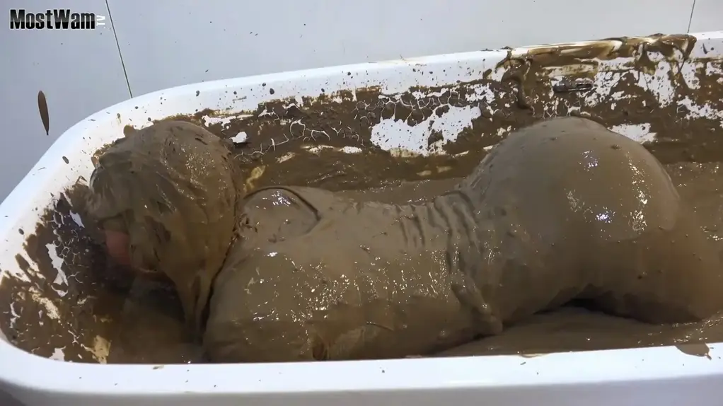 Lila’s Mud Practice One of our new girls, Lila, has some mud shoots coming up for www.mostwam.tv<br>So, we thought it best to try her out getting muddy in the mud bath at the office.<br>Wearing her own clothes, she gradually covers herself in our glorious creamy mud.