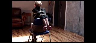 mpzonah13c The tight paracord keeps Zonah helplessly tied to her chair. Her struggle is useless