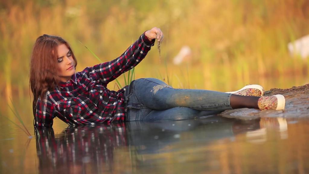 SEXY GIRL IN FULLY WET JEANS, SHIRT, TIGHTS AND SNEAKERS wetfoto<br>Are you ready to have some fun with this fully clothed wet girl? So join us and take pleasure! This is Jenny. She wears checkered shirt, blue jeans, black socks and shoes. At first, girl makes a few steps into the lake and plays with the water. She takes a handful of water to cool her neck and hair. She feels warmer and warmer and starts wetting her jeans and shirt. Now she is soaking wet. Then she lies down on the shore and let the waves surround and embrace her. Wet girl feels like a mermaid. This is an unforgettable feeling.<br><br>