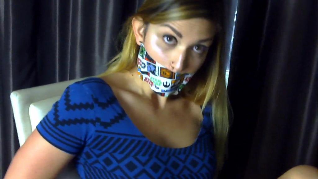 Ayla Cuffed &amp; Stuck HD I have no idea how gorgeous Ayla Aysel wound up handcuffed, her ankles tied together with rope, and her mouth gagged with Star Wars duct tape. She might have done it to herself--she does that to herself sometimes. At any rate, it looks like she doesn't have the key so she is a bit stuck. She tries to slip out of the cuffs but they're on too tight. She hops around the room looking for the key but it's nowhere around. The frustration mounts as she realizes freedom isn't coming anytime soon. When I walk in, she gets a glimmer of hope that is quickly shattered when I leave her, not wanting to interrupt her play. Now all she can do is hope she can find that key.