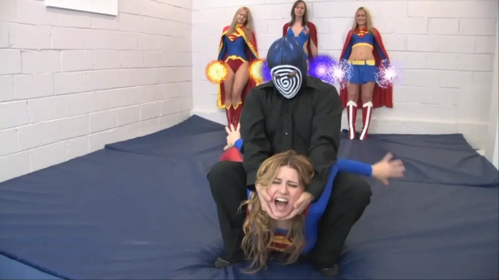 HEROINE CRISIS Four different Supergirls from different dimensions (played by Jacquelyn Velvets, Ivy, Serena, and Alisa) are kidnapped by the evil SK-1000 at the behest of an evil mastermind (voiced by George Perez) and forced into one on one combat against the powerful cyborg!   The heroines try their best to subdue their attacker, only to eventually fall into a pile at his feet!