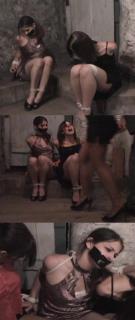 Angela, Jessica, Destiny - Basement Captives Jessica and Angela are bound captives in the Hunter's cellar. Ropes cruelly lash their elbows and wrists tightly together behind their backs. And their ankles and knees are tied together tight. They struggle to get close to each other and to reach the other girl's knots. It is a slow painful process but they do manage to get some of the knots worked loose before the Hunter returns with another bound captive, Destiny. He attaches Destiny's bound arms to an overhead hook and reties the other two girls tight. Then moves Destiny to a place next to the other two. The three of them fight the best they can still trying to get at each others knots while the Hunter is occupied with another girl. But he makes it tough on them by attaching all three girls together with one long section of rope. After he leaves the girls continue the struggle to get free. But although they do manage to get free of some of the ropes, their elbows remain cruelly bound tight and the rest of the knots are too elusive for their numb but nimble fingers. (14:23 minutes of three girls struggling)