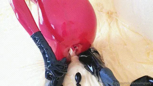 Lalola clad in latex plays with two inflatable toys Playing with two inflatable toys while wearing my red catsuit with integrated vaginal and anal condoms. My poor rear opening is terribly tight but I hope by using these plugs regularly it will help. Afterwards, some dude emptied his load in my condomed rear. Poor me, hihi!