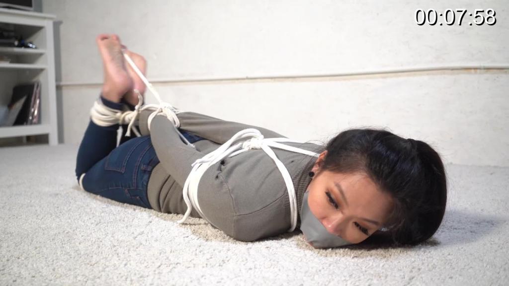 4083 Louisa in Barefoot Sweater Hogtie Louisa (Ophelia) is wearing a beautiful green sweater, jeans and sneakers. She kicks the sneakers off and the socks and gets ready for a hogtie. Tied with white ropes, her toes are also tied. A piece of tape is used as a gag.
