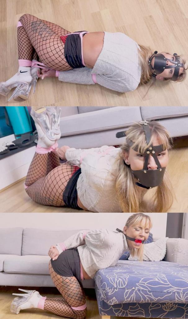 Renee's Avarice Leads to a Harsh Hogtie and Head Harness silence (BTS) 在一家著名建筑公司熙熙攘攘的总部，权势显赫的首席执行官拉蒂娜坐在办公桌前，目光犀利地浏览着一份紧急报告。报告上的文字证实了她的怀疑：她野心勃勃的同事蕾妮正密谋篡夺她的职位，为自己夺取首席执行官的头衔。拉蒂娜眼中燃起一股怒火，她知道她必须迅速采取行动。<br><br>拉蒂娜把蕾妮叫到办公室，保持着冷静沉着的态度，当对手走进房间时，她坚定的目光从未动摇。蕾妮不知道，拉蒂娜发现了蕾妮的真实意图：窃取公司最敏感的信息，并利用这些信息作为她追求权力的筹码。<br><br>设下陷阱后，拉蒂娜立即与蕾妮对质，揭露她的阴谋。随着两个女人激烈地争吵，气氛变得紧张，她们的声音在意志的激烈冲突中越来越大。最后，拉蒂娜受够了。是时候惩罚蕾妮的不忠，确保她再也不会威胁到拉蒂娜的地位了。<br><br>拉蒂娜控制了局面，熟练地用绳子将蕾妮紧紧地绑在皮肤上，使她动弹不得，无助无助。当蕾妮开始抗议时，拉蒂娜迅速用袜子堵住她的嘴，让她闭嘴，她的沮丧和决心从她的每一个动作中都可以看出来。<br><br>被绑住嘴的蕾妮徒劳地挣扎着想要挣脱束缚，但拉蒂娜熟练地绑住的绳结牢牢地绑住了她。拉蒂娜的意思很明确：不忠是不能容忍的，蕾妮会一直被绑得很紧，直到她吸取教训，在袜子上面加一个束带塞口。<br><br>随着时间一分一秒地过去，蕾妮的反抗慢慢让位于顺从，当她意识到自己的挣扎是徒劳的时候，她的身体因失败而下垂。拉蒂娜满意地看着她的对手接受惩罚，确信她保住了自己的地位并保持了对自己辛苦建立起来的公司的控制权。In the bustling headquarters of a prominent construction company, the powerful CEO Latina sat at her desk, her sharp eyes scanning an urgent report. The words on the page confirmed her suspicions: her ambitious colleague Renee was plotting to usurp her position and claim the CEO title for herself. A fire ignited in Latina's eyes, and she knew she had to take swift action.<br><br>Summoning Renee to her office, Latina maintained a calm and composed demeanor, her steely gaze never wavering as her rival entered the room. Unbeknownst to Renee, Latina had discovered her true intentions: to steal the company's most sensitive information and use it as leverage in her quest for power.<br><br>With the trap set, Latina wasted no time in confronting Renee about her treacherous plan. The air grew tense as the two women exchanged heated words, their voices rising in a bitter clash of wills. Finally, Latina had had enough. It was time to punish Renee for her disloyalty and ensure that she could never threaten Latina's position again.<br><br>Latina took control of the situation, skillfully binding Renee with ropes tight into her skin, leaving her immobilized and helpless. As Renee began to protest, Latina swiftly silenced her by gagging her with a sock, her frustration and determination evident in every movement.<br><br>Bound and gagged, Renee struggled futilely against her restraints, but Latina's expertly tied knots held fast. Latina's message was clear: disloyalty would not be tolerated, and Renee would remain tightly tied until she learned her lesson adding a harness gag on the top of the sock.<br><br>As the minutes ticked by, Renee's defiance slowly gave way to resignation, her body sagging in defeat as she realized the futility of her struggle. Latina watched with satisfaction as her rival accepted her punishment, secure in the knowledge that she had protected her position and maintained control over the company she had worked so hard to build.