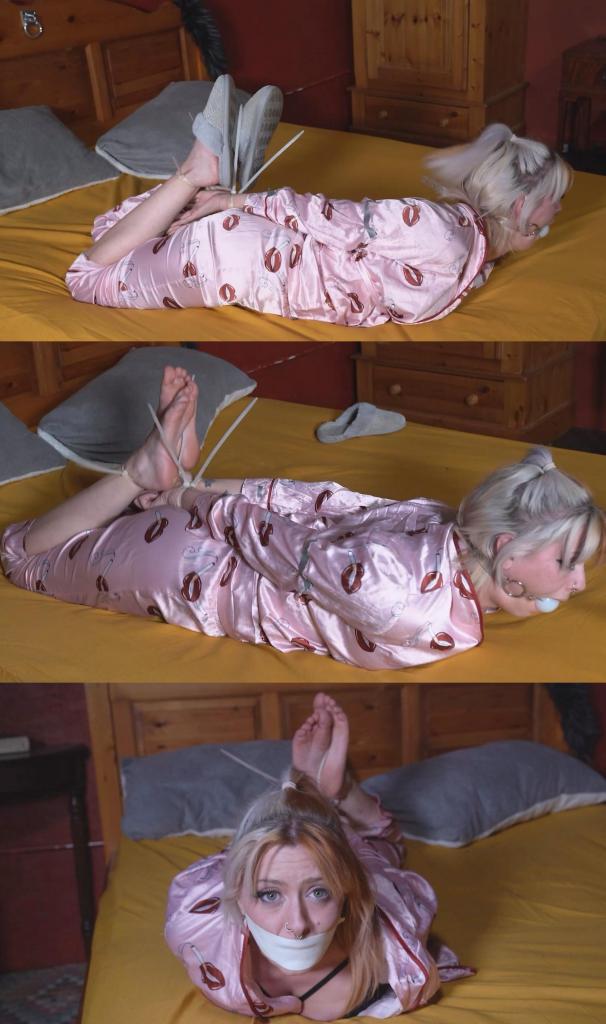 4191 Amber in Satin Pyjamas Hogtied Amber 躺在床上。她穿着漂亮的睡衣，突然被人抓住，用拉链绑住，嘴里塞住球。随后发生了争斗。连她的拖鞋都掉了（她为什么在床上穿着拖鞋？）Amber is in bed. Wearing her fancy pyjamas she is suddenly grabbed and ziptied and ballgagged. Struggles ensue. Even her slippers come off (why was she wearing them in bed?)