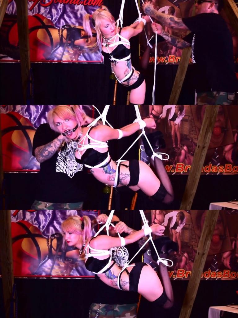 Suspended at Fetishcon 小丑女吊缚<br>The suspension was the talk of the convention as people stopped in their tracks to watch the gorgeous goth girl, Trip Six, hanging there helpless.. She was a vision in her black satin lingerie, stockings, and heels, her porcelain skin contrasting beautifully against the black satin.<br><br>As the suspension began, Trip Sixs body was hoisted in mid-air, her arms and legs tightly bound by ropes, and a metal ring gag securing her mouth open. The drool dripped down her chin uncontrollably, adding to the mesmerizing effect of the scene. Passersby couldnt help but stop and take pictures, captivated by the display of submission and vulnerability.<br><br>But it wasnt just for show. I had carefully tied a crotch rope that added an extra element of sensuality to the suspension. The rope bore some of Trip Sixs weight, causing her to squirm and writhe in pleasure as she hung there. The crotch rope was also soaked through, evidence of the intense arousal she was experiencing.<br><br>It was a live performance, and the background noise and convention chatter only added to the atmosphere. The onlookers were a mix of awe, curiosity, and arousal, their presence adding to the thrill of the her vulnerability. And as I finally let Trip Six down and untied her, the audience erupted in applause, impressed by the beautiful and daring display.<br><br>It was a moment that will be remembered, a perfect blend of art and kink that showcased the beauty and power of submission. And as we walked away from the suspension, Trip Sixs body marked with rope marks and her hair tousled, we couldnt help but smile at the memories we had created together.