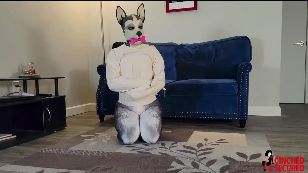 1663 - MinxGrrl - Bad PupGirl Gets Straitjacket and Gag! Today MinxGrrl was a very bad puppy, getting into all the things she was not supposed to get into. In order to keep her out of mischief, her owner strapped MinxGrrl into a straitjacket and gagged her with a big pink bone!  She struggled like mad, flipping and thrashing and straining against the canvas, but she couldn't escape no matter what! The tight crotch strap rubbed against her puppy parts, causing her to lose focus on escaping.  Eventually, she gave in and simply lay back, humping the strap as she moaned. She knew this was supposed to correct her behavior, but I have a feeling she's going to act up every chance she gets if she can spend more time in the jacket!!!