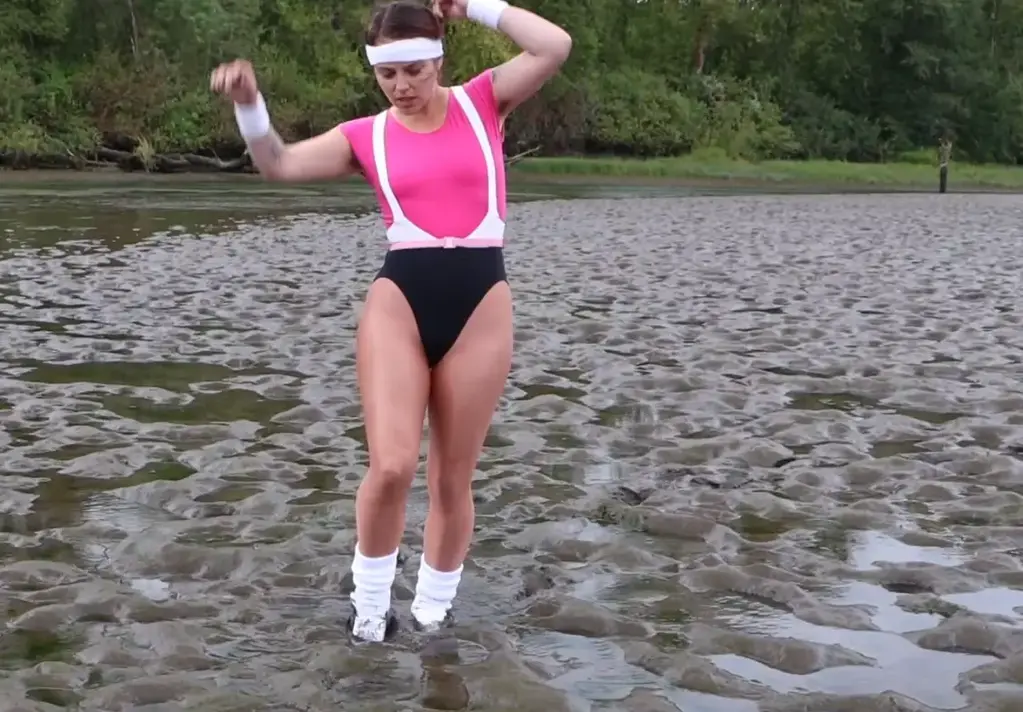 All But Lost, starring BabyFilth BabyFilth is quite spunky in her cotton suspender leotard, shiny tights, thick white socks, and athletic shoes. But she is no match for what fate awaits her. Flexing her muscles, she then gallops along the sand and steps awkwardly across quivering ground. The sand liquifies beneath her shoes and slowly draws her in...sinking up past her ankles, her shins, her knees, he thighs, and then to her waist. Only when she is up to her thighs does she realize her peril. She struggles and fights the sucking sand, hitting it and swinging about wildly. She sinks in all the way to her shoulders before nearly giving up. After a fadeout, she is rescued by an offscreen, silent presence. They pull her out with a large stick. The quicksand is real: it does not want to give up its trophy. But it finally relents as BabyFilth pulls free. If you like to watch someone struggle hard against real quicksand, this movie is for you.