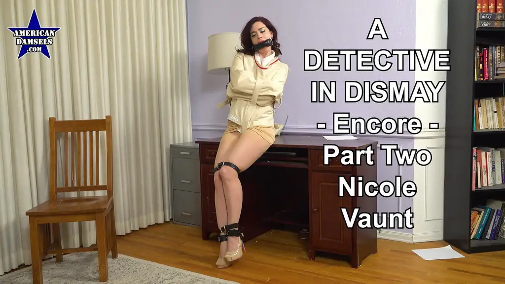 A Detective In Dismay - Encore - Part Two - Nicole Vaunt Thrill to this bondage adventure from a new angle with the encore version of the tale! The story continues a few days later. Private detective Nicole Vaunt is in her office when she gets an unexpected delivery. She immediately recognizes the delivery person as "Paul" -- the same villain who invaded her apartment several nights before! She cautiously opens the box and pulls out a straitjacket. Her helpful visitor assists the dazzling detective into the canvas coat, and he bends her over her desk to pull the straps tight. He then utilizes black leather straps to insure Nicole's shoes stay on her feet, and he employs additional straps to bind her ankles and knees. Ms. Vaunt remains defiant, but her indignant responses to the villain are concluded when he buckles a padded bit gag into her mouth. Paul tells the trussed-up detective not to cause any trouble while he waits for an opportune moment to get her down into his waiting car. Naturally as soon as he's out of sight, our plucky damsel tries her best to find a way to phone for help, or get into her purse to see if there's anything in it that could aid in her escape attempt.  Her courageous efforts all go unrewarded, and the sexy shamus is still powerless when the bad guy returns. He can't help but notice Nicole's unsuccessful bid for freedom, so he pulls the exquisite brunette up onto her desk and uses a pair of leg irons to hogtie her. The intrepid private eye continues her losing struggle to liberate herself, yet she's still strapped up when Paul comes to collect her and hop Nicole into the final chapter of this knotty adventure.