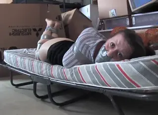 2503SERENE-Taped in her basement Serene is taped tight at first on a cot in her basement... Her predicament could get worse though!