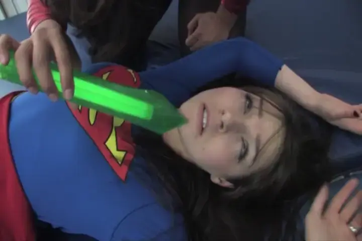 SUPER-NATASHA vs SAPPHIRE our superheroine Super-Natasha waits on her mystery opponent, we see the vicious Sapphire emerge from the shadows…holding Natasha’s only weakness in her hands!  We see Natasha slowly succumb as Sapphire places the green krystal close by and begins a one-sided superheroine squash.