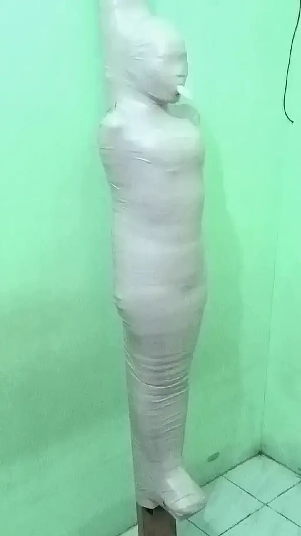 [POV] Main Scene Of RandyMummify RM099 A girl with long hair wearing an orange swimsuit is mummified on top of a large stick with a white cloth.<br>This girl was helpless when her nose was closed and only breathed from a small tube