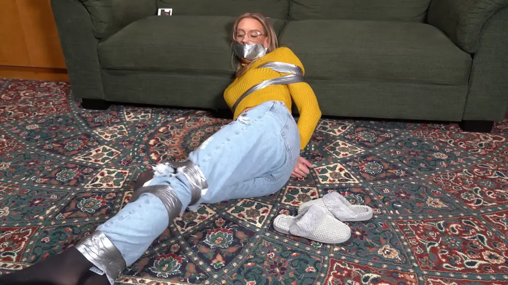 3223 Layla in Jeans and Tights Tape Up Layla is watching TV and some rubbish bondage is shown. She decides she wants to try it, calling a take out from AGB. She is rapidly taped up, still in her slippers. Awesome.