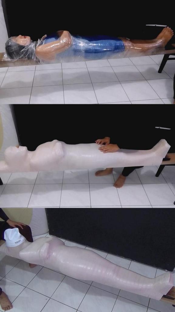 [POV] Main Scene Of RandyMummify RM129 A beautiful girl is mummified tightly on top of a stick. The girl's body was wrapped tightly so it was difficult to move. When the girl's body was not holding onto her legs, her face was covered by the latex swim cap so that the girl could not breathe.