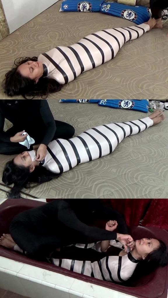 [POV] Main Scene Of RandyMummify RM133 A beautiful girl is mummified in a hotel room with white duct tape reinforced with black duct tape. After this girl was helpless, her head was covered with a swimcap so that this girl struggled