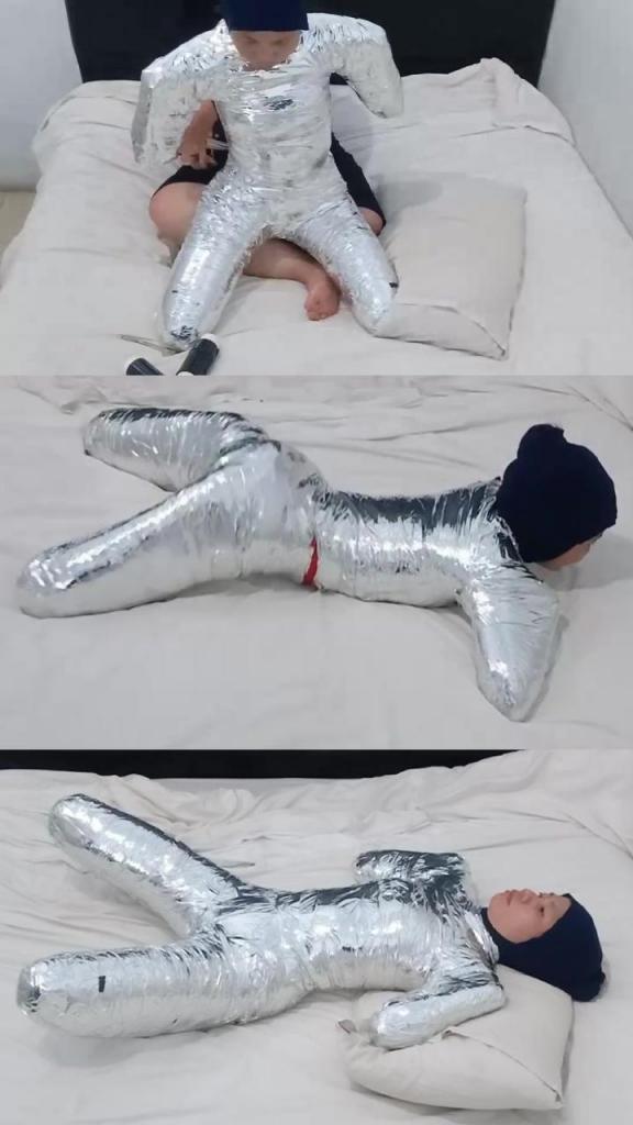 [POV] Main Scene Of RandyMummify RM161 This Girl Was Wrapped Tightly With Chrome Duct Tape Like A Helpless Pet. Her hands and feet were wrapped folded in a package, paralyzing the girl's movements.