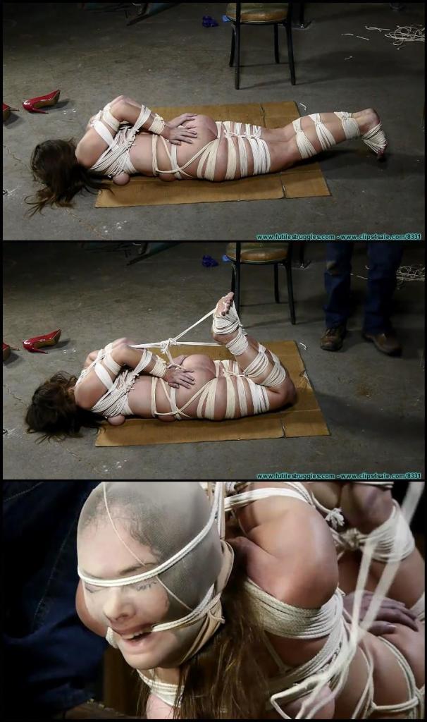 Rachel Endures 600 feet of Tightly Cinched Rope - Part 3 This clip starts where Part 2 ended. I keep adding more rope to Rachel's upper body, and I also remove her gag as I have another gag in mind. Rachel is placed on the floor and at this point you can really tell that Rachel is in real distress. If Rachel is in distress then you know that the ropes are tight! She whimpers and yelps as I pull her into as tight of a hogtie as I think she can handle for now. I give her a little time to adjust before I intensify the hogtie by utilizing the overhead hoist. I leave Rachel to adjust and acclimate to her bondage for a short while, before hooding her with a nylon stocking. I then tie it back and then intensify it even more by gagging her with rope and tying it back as well. A few wraps of rope around her forehead and then tied back completes her gag. This was not the gag I had in mind, but at this point, I needed to do something quickly. This is where Part 3 ends. 