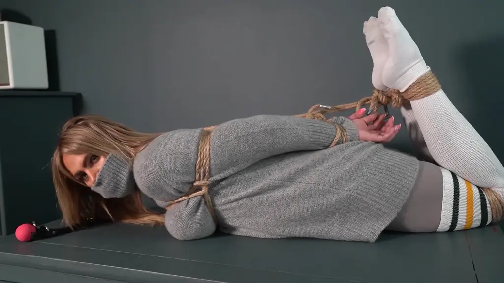 2233 Charlotte in Grey Sweater and Old Rope Charlotte is dressed in a lovely rollneck grey sweater, grey tights and long sports socks. She gets tied to a chair by some old rope. Then hogtied while the roll of the sweater is pulled up over her face.