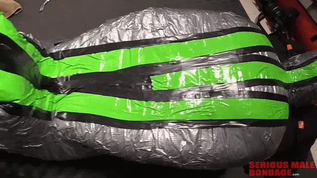 Mummy Art 【中文】这是我们听球赛时制作的一个很酷的木乃伊。随意的束缚可能会在研究所发生，当人们来参观时，这真的很有趣。在这种情况下，Prima2（侦察员）穿着氨纶和乳胶风帽来访。我想他被木乃伊化后就睡着了，或者至少他完全放松了。This is a cool mummification by our friend MummyEd while he was listening to the ball game on his iPad. Casual bondage can happen here at the Institute which is real fun when people come to visit. In this case Prima2 (recon) was visiting in his spandex and latex hood. I think he ended up going to sleep once he was mummified, or at least he was totally relaxed. I guess that's one of the reasons people love bondage and enclosure and tight mummification. It's like a mini vacation from the stress of daily life. Ahhhh....