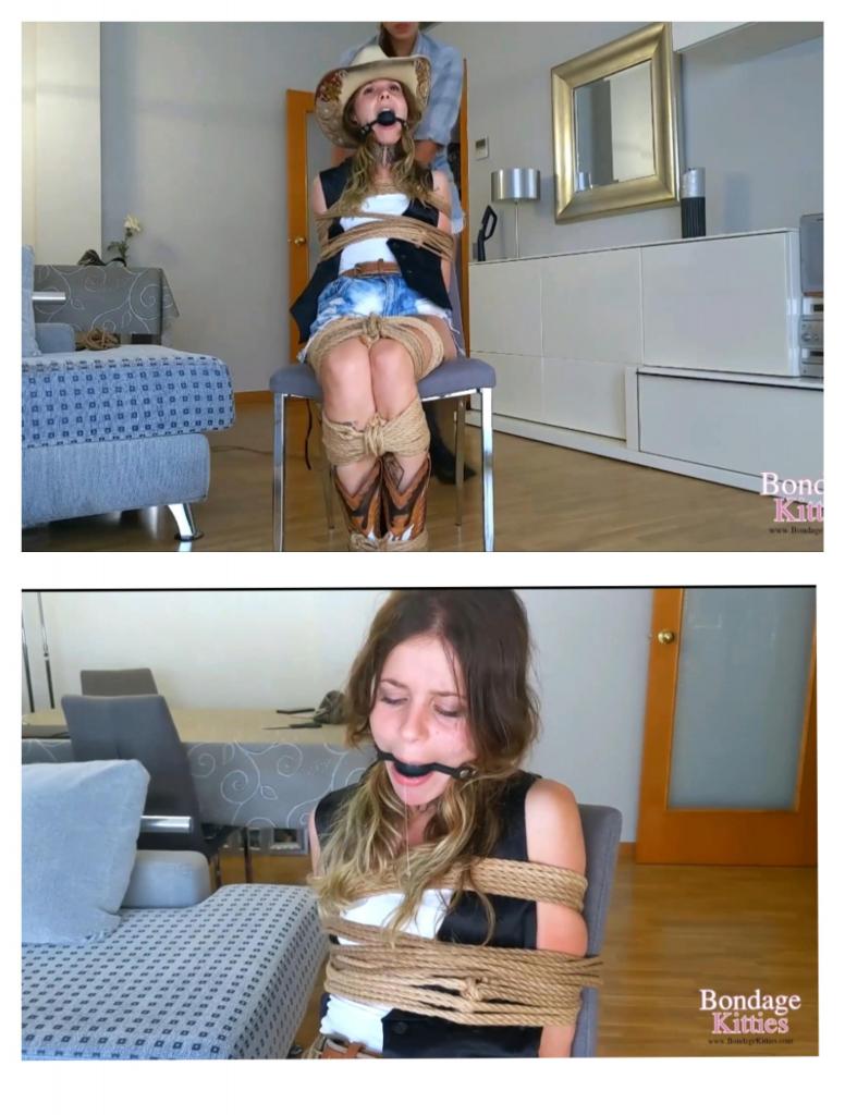 Cowgirl tied up in chair by Cowgirl Aly had everything ready for the cowboy themed festival fashionable clothes, new cowboy boots, and her partner Lex's stolen cowboy hat. She thought she could take him without permission, but Lex had other plans. Just as Aly finished dressing, Lex walked in and caught her red-handed. Knowing she wouldn't listen to excuses, he quickly restrained her, tying her hands behind her back with a neat rope. To keep her quiet and obedient, he placed a ballgag tightly between her lips, muffling any protests.