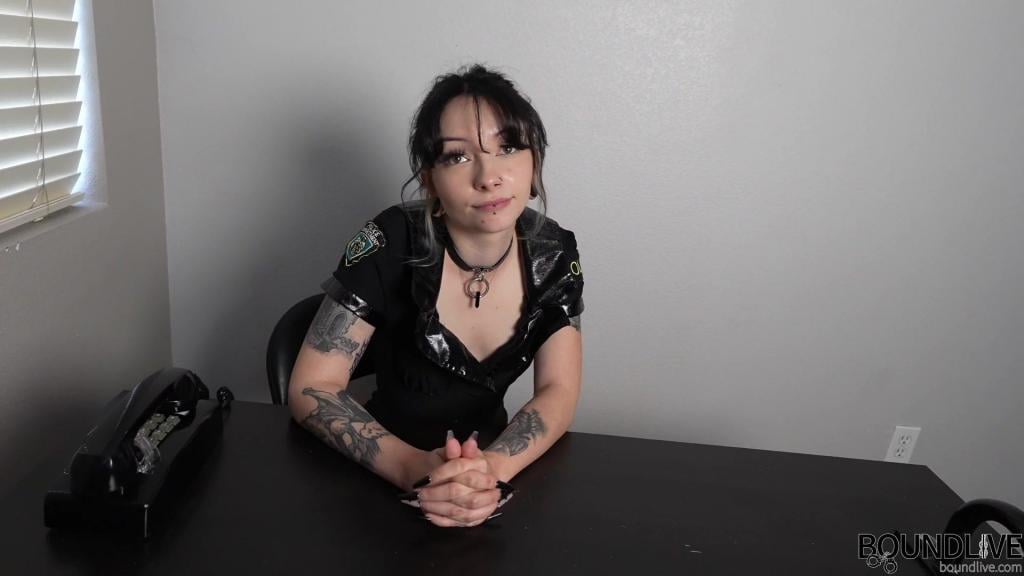 Corrupt Cop Olivia is Arrested Olivia is a corrupt cop, accepting bribes and extorting people who come to pay their fines. Officer Mia Brooks finds out and places her under arrest. She handcuffs Olivia behind her back with a pair of hinged cuffs